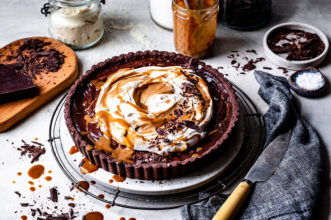 Chocolate caramel tart with whipped coconut cream, caramel and chocolate shavings.