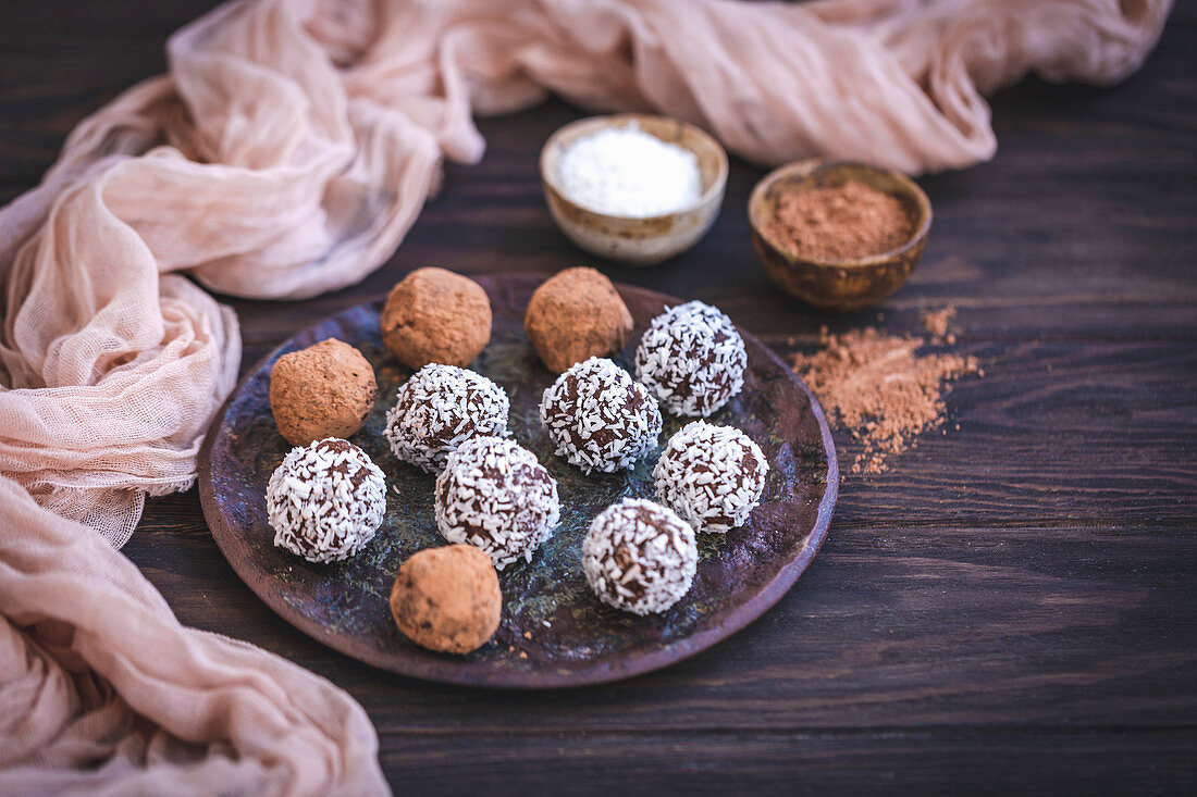 Homemade chocolate almond truffles served on a ceramic plate