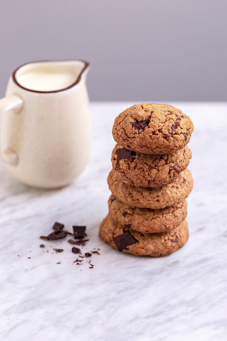 Stack of oats chocolate chip cookies on a white marble table