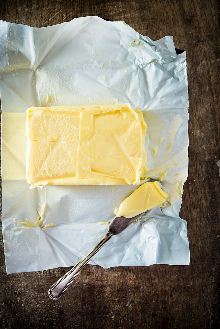 Butter with a knife on butter paper
