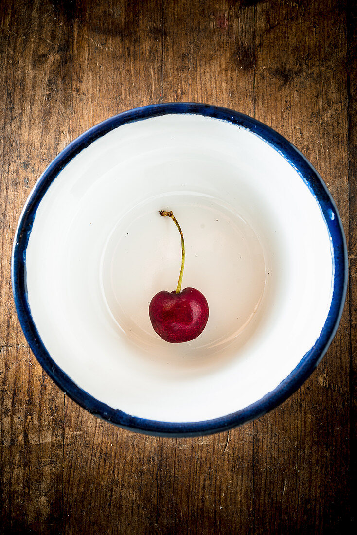 Cherry in an enamel bowl