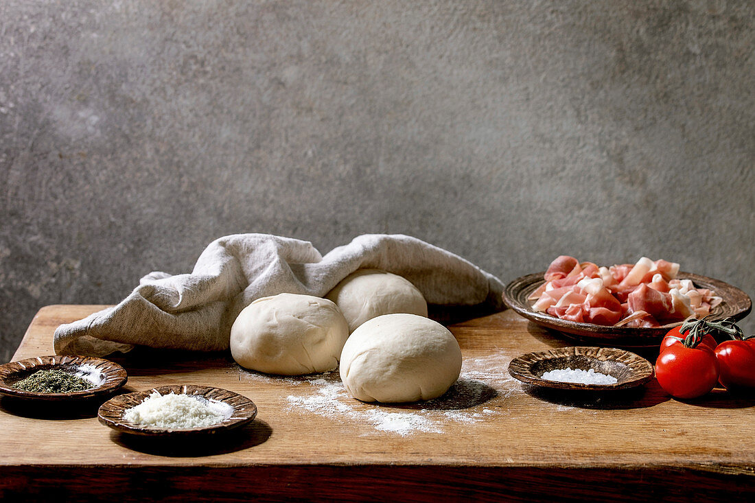 Balls of dough and ingredients for Pizza Napoli