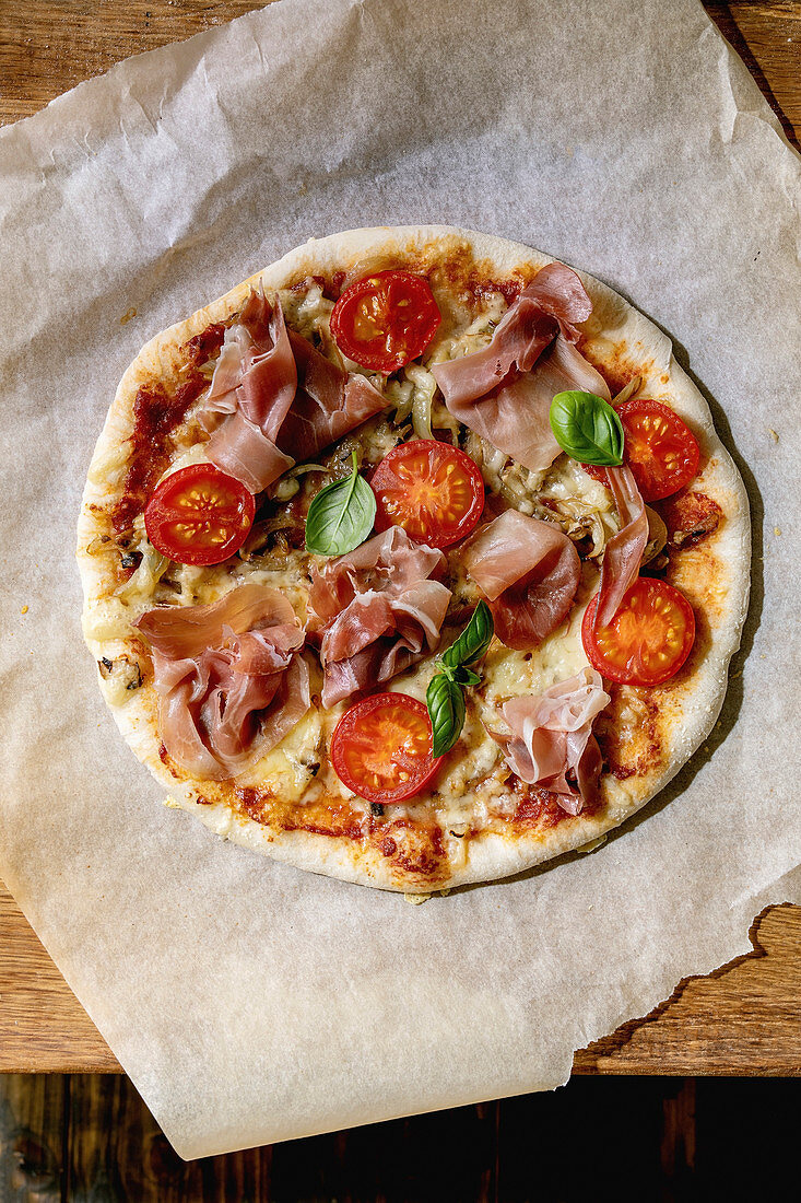 Pizza Napoli with ham and tomatoes