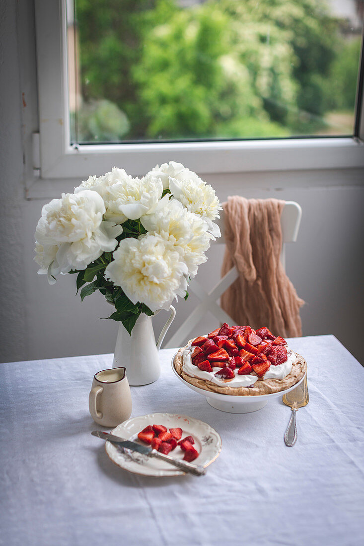 Pavlova cake with whipped cream and strawberries