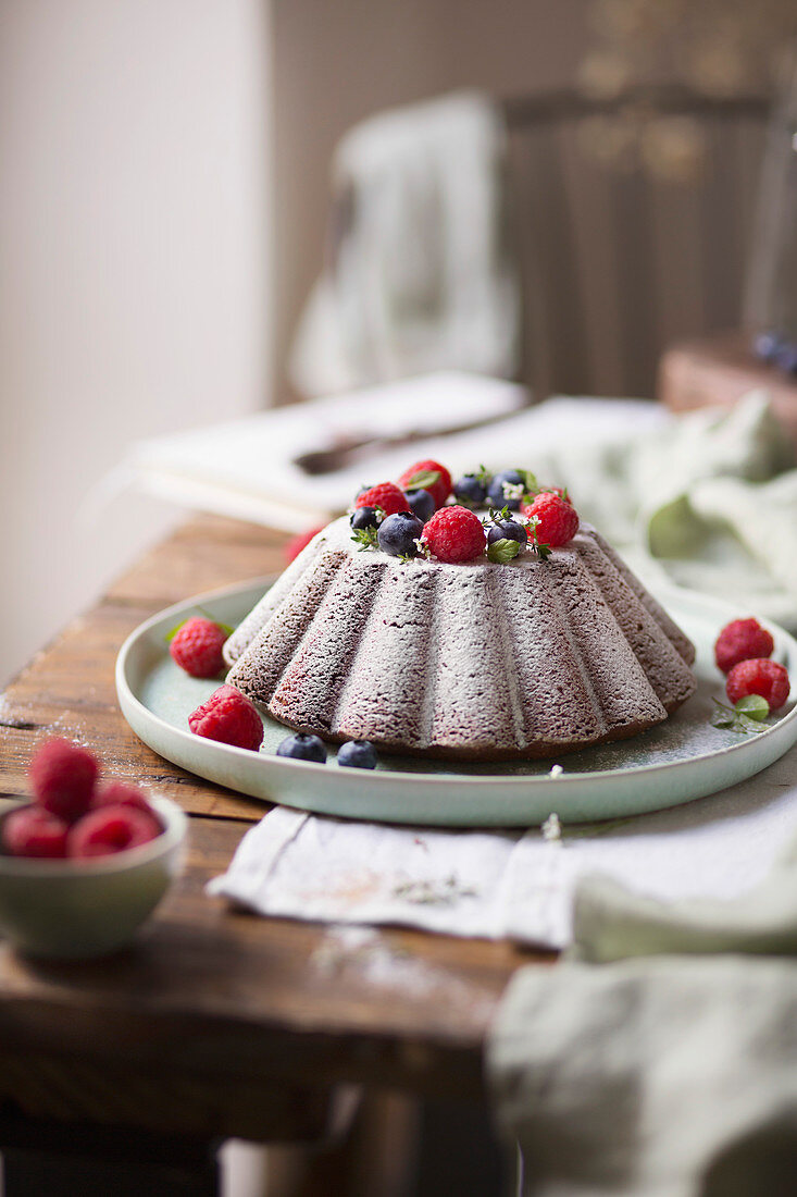 Cake with raspberries and blueberries on the table