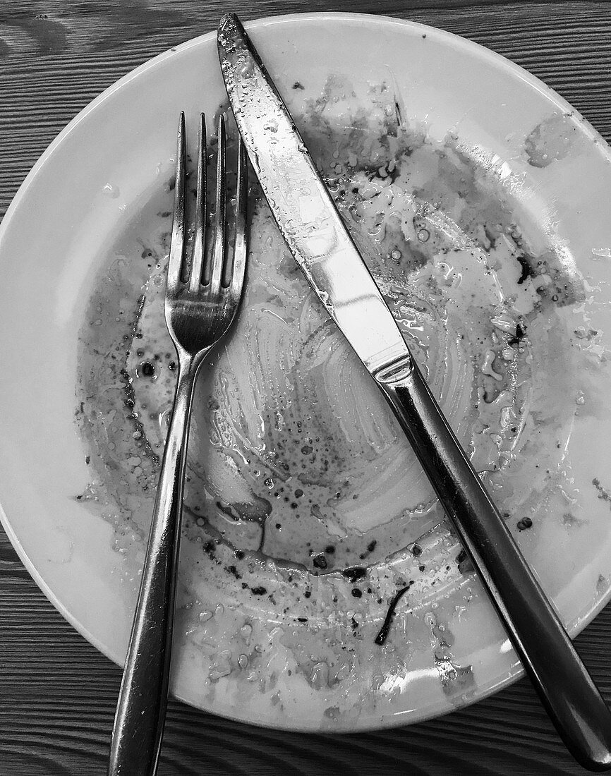 Dirty plate with cutlery