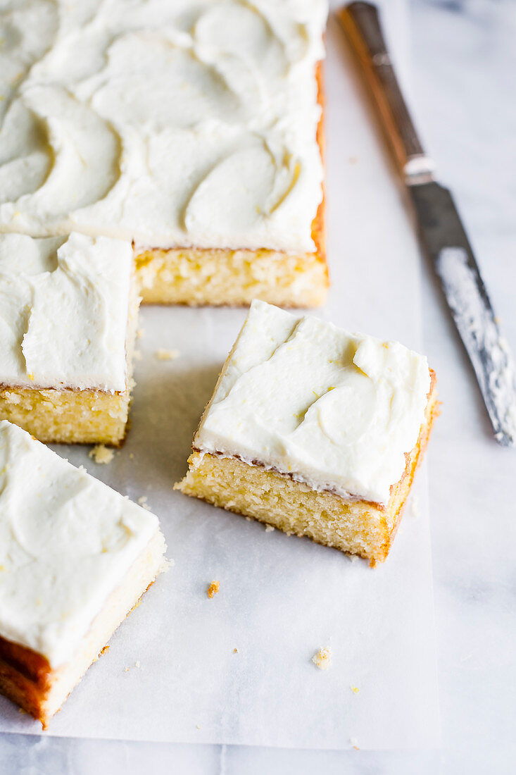 Vanilla sheet cake with whipped lemon buttercream frosting.