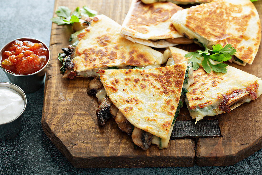 Mushroom, spinach and cheese quesadillas with sour cream and salsa