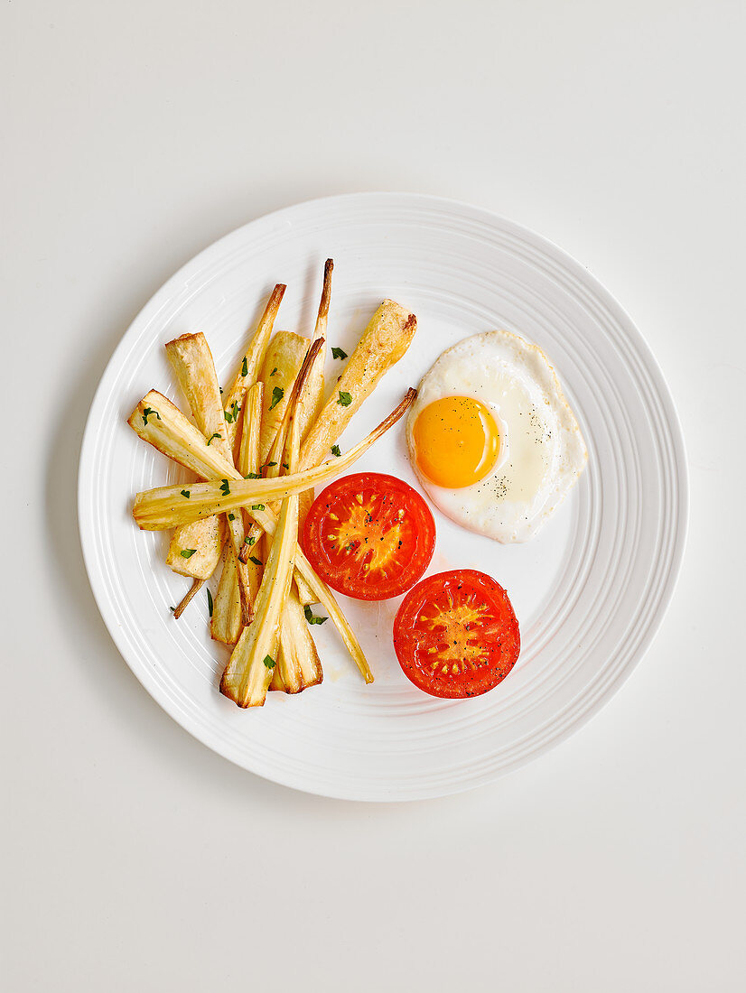 Parsnips fried in honey with fried egg and tomato