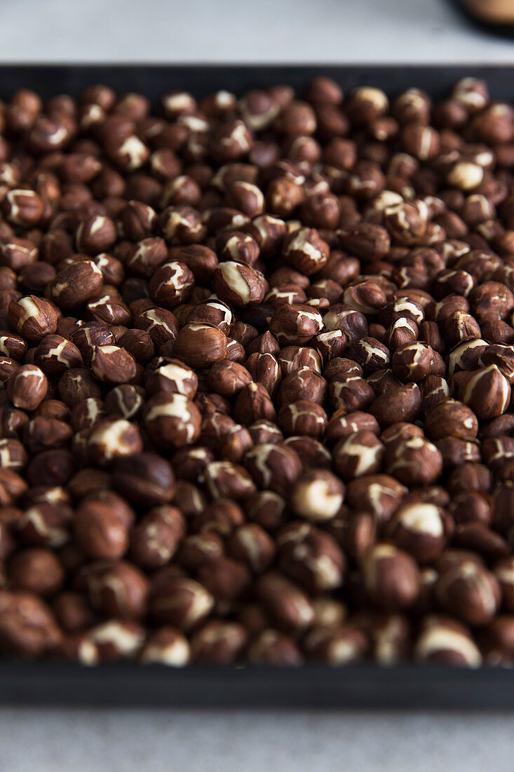 Roasted hazelnuts on a baking tray