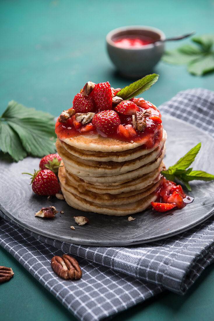 Vegan pancakes with strawberry compote, pecans and mint