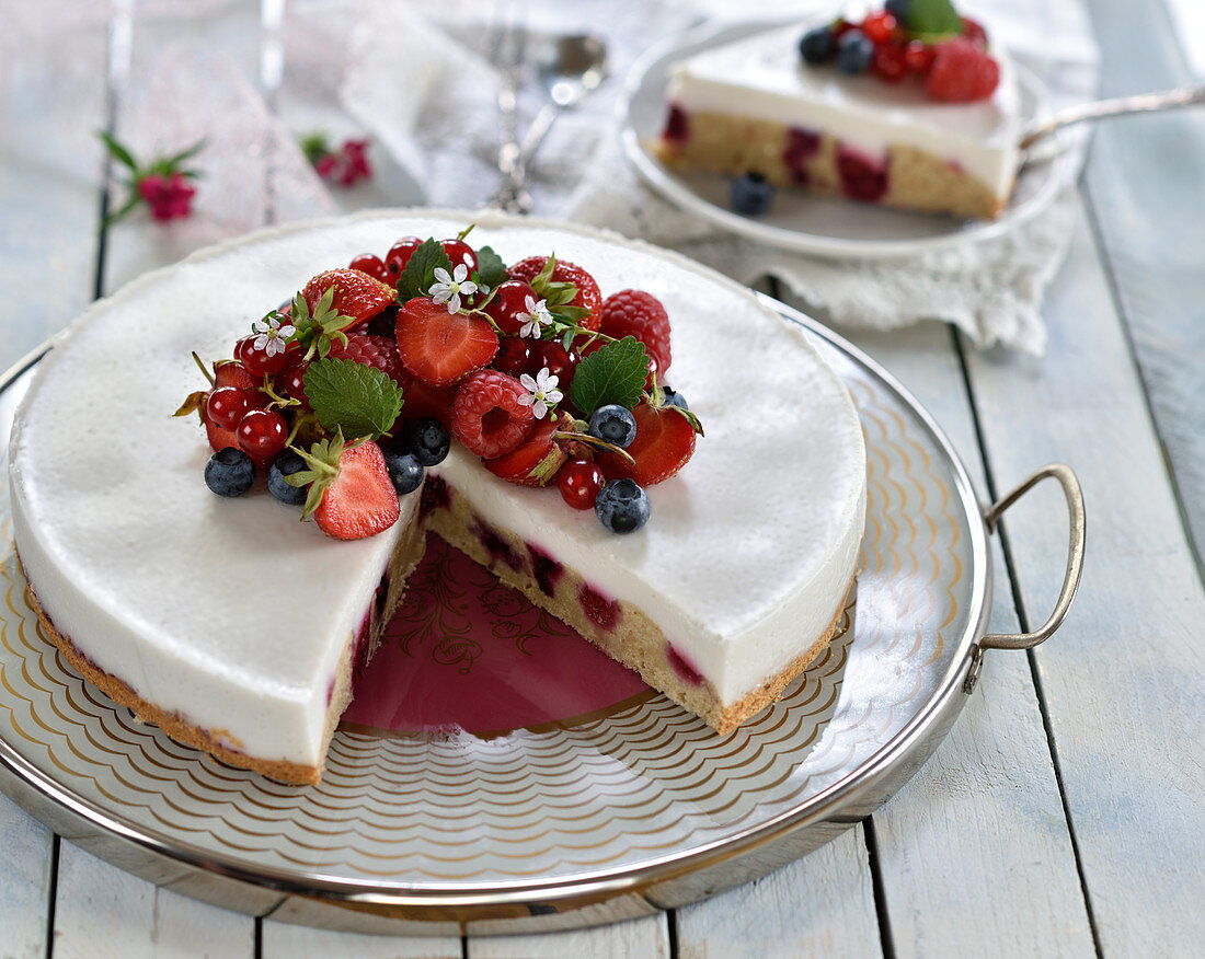 Vegan panna cotta cake with a sponge base and summer berries