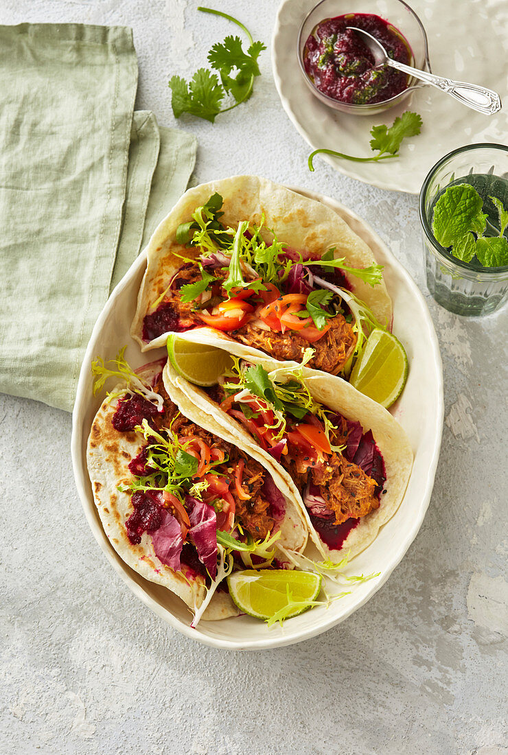 Tacos with beet paste and shredded meat