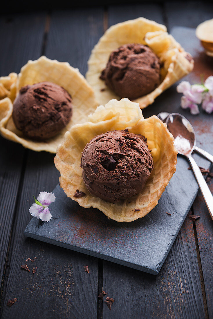 Vegan chocolate ice cream with chocolate chips in waffle shells