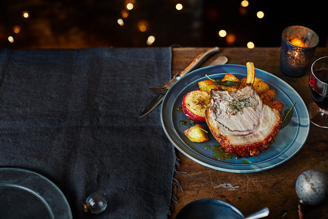 Roasted pork with sage and double onion stuffing, served with baked apples