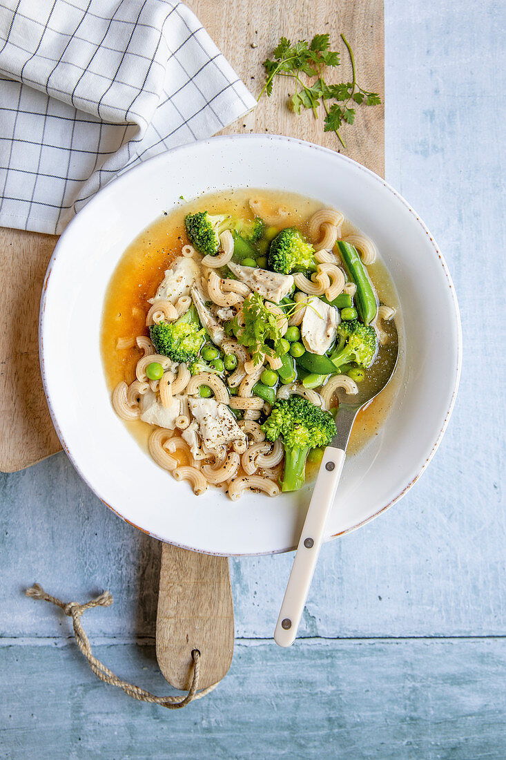 Chicken soup with noodles and green vegetables