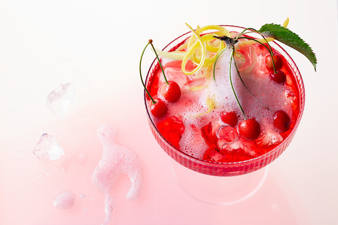 A cherry cocktail with gin, ginger ale and mini wild cherries