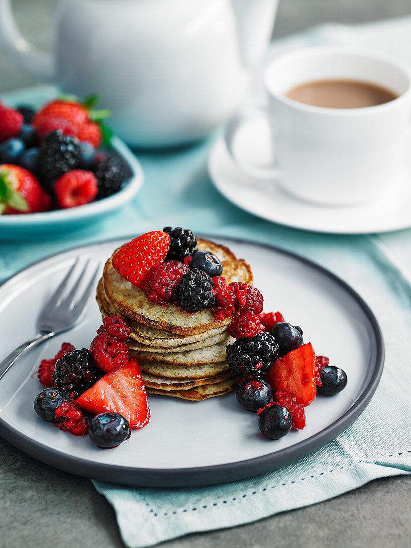 Flaxseed, oat and banana pancakes with crushed berries