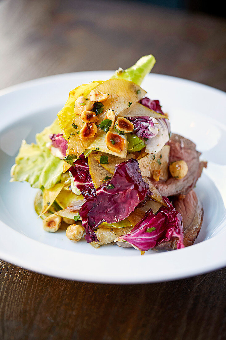 Roast venison and pear salad with toasted hazelnuts
