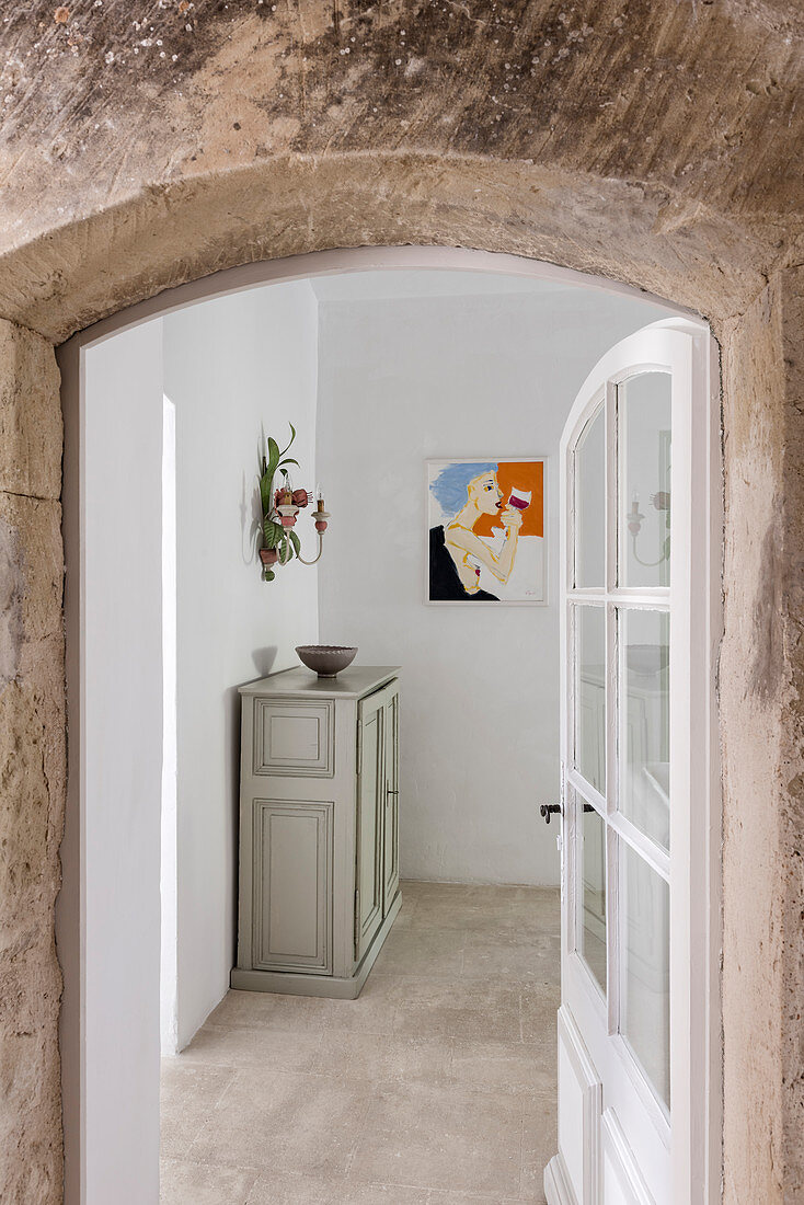 Cabinet in farmhouse seen through open front door