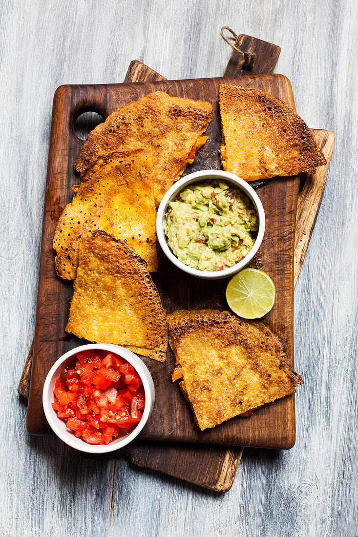 Quesadillas with chicken fajita filling, guacamole and tomato salsa