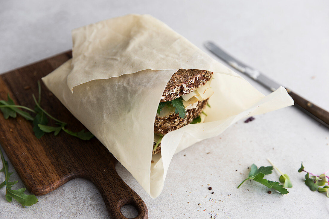 Wholegrain sandwiches with cheese wrapped in paper