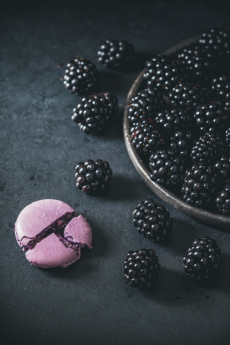 Purple macaroon and blackberries on the plate