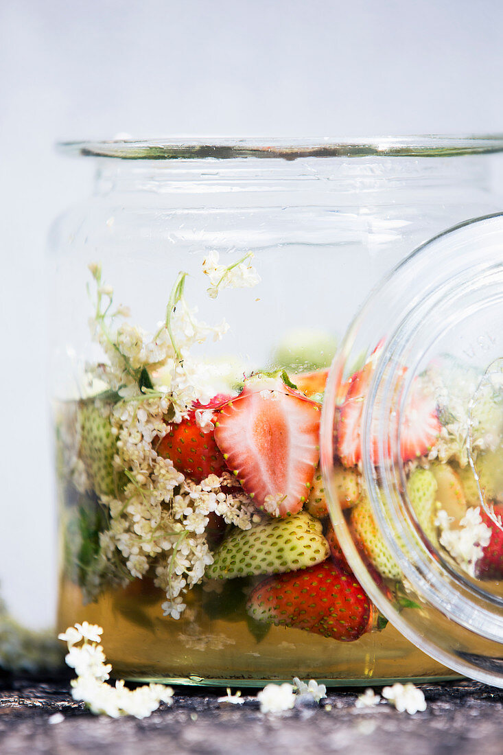 Preserved red and green strawberries with elderflower syrup