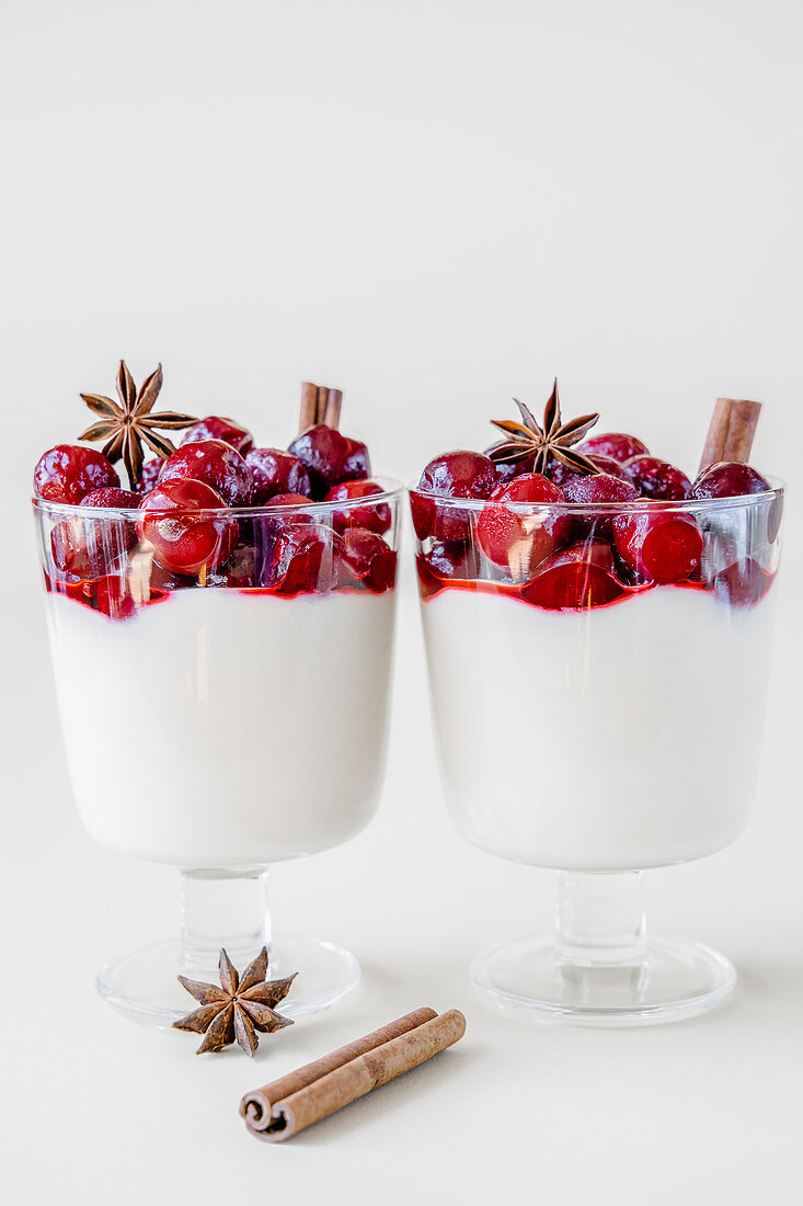 Vanilla pudding topped frozen cherries, star anise and cinnamon sticks