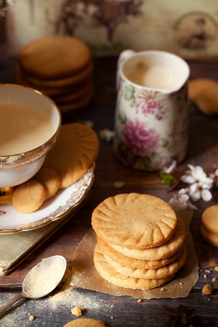 Homemade malted milk biscuits alongside a cup of tea and a jug of milk