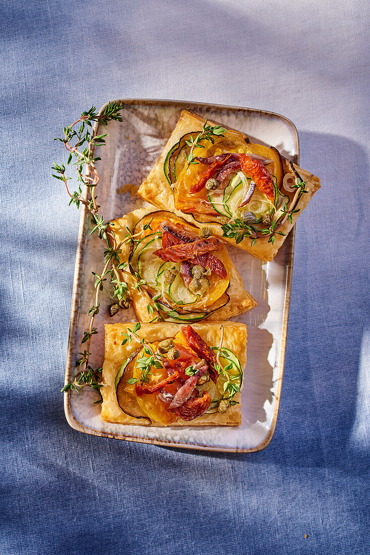 Puff pastries with vegetables, anchovies and thyme