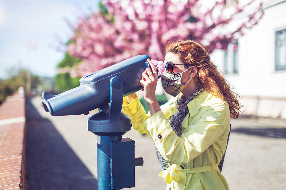 Woman using coin-operated binoculars