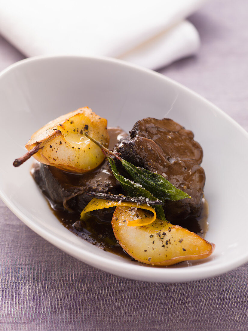 Braised shoulder of venison with caramelised pears