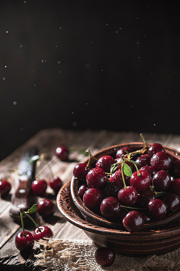 Wet cherries in a clay bowl