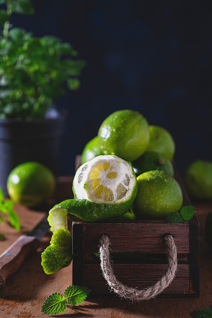 Fresh wet limes in a wooden box