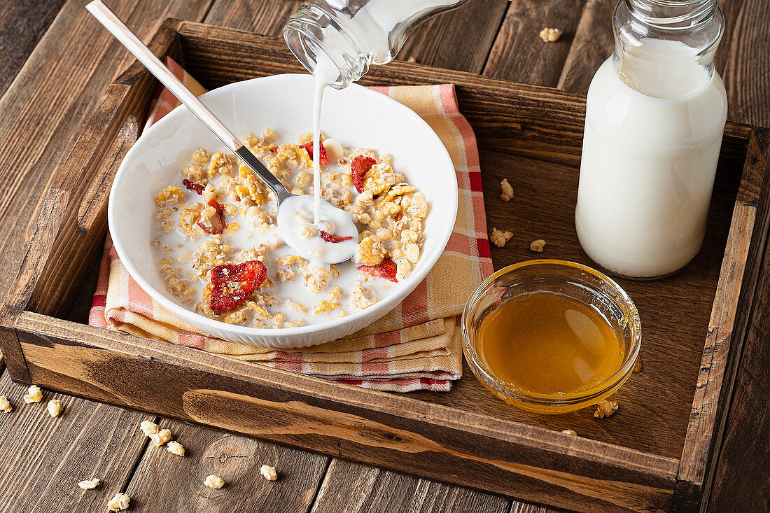 Milk being poured onto muesli