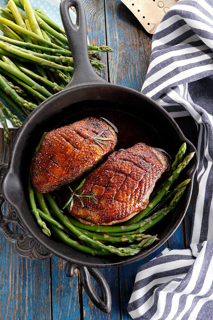 Roast duck breast with green asparagus