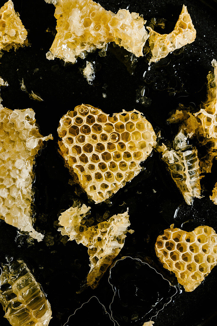Honeycomb in heart shape on black background
