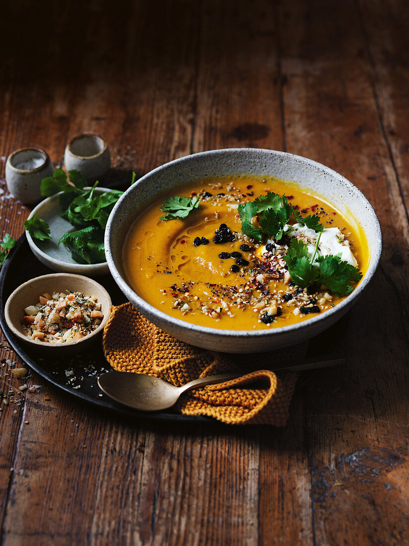 Spice-roasted pumpkin soup with macadamia dukkah