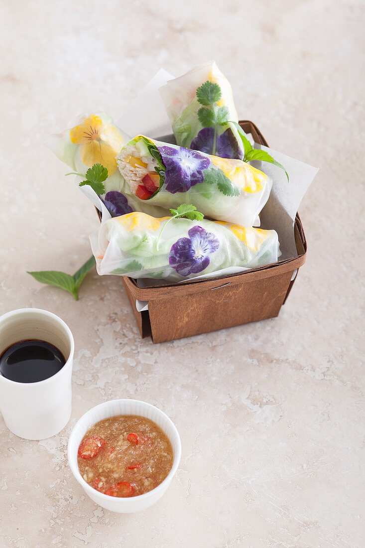 Summer rolls filled with kelp noodles and edible flowers