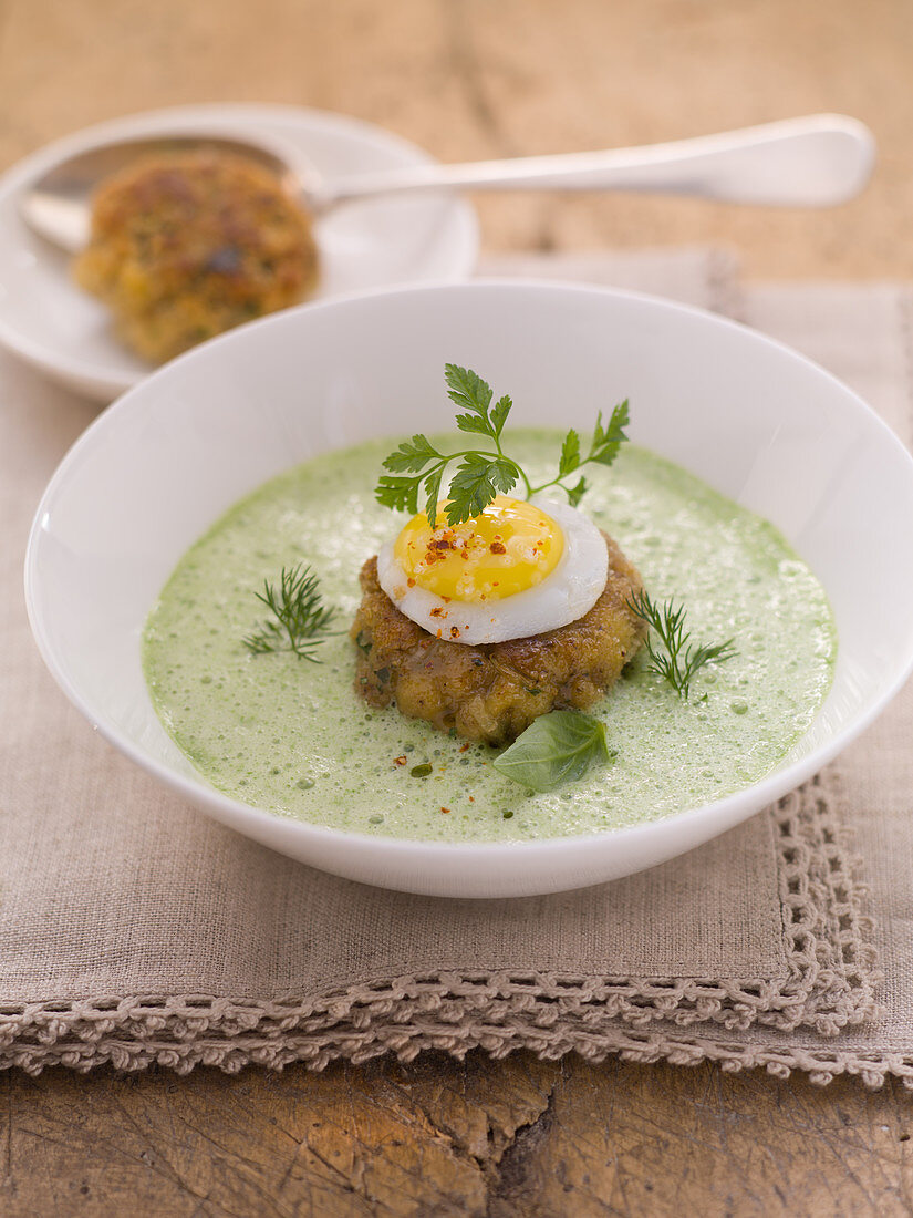 Frothy herb soup with a fritter