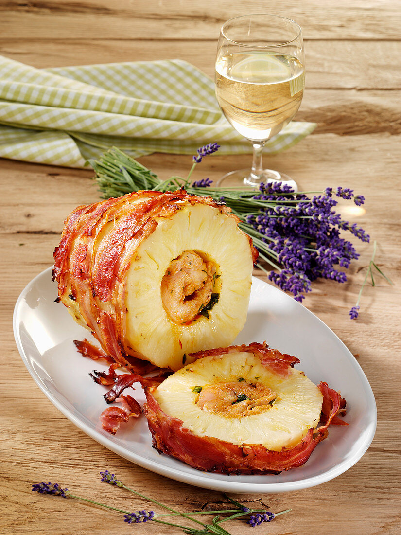 Pineapple wrapped in bacon with a spicy chicken filling