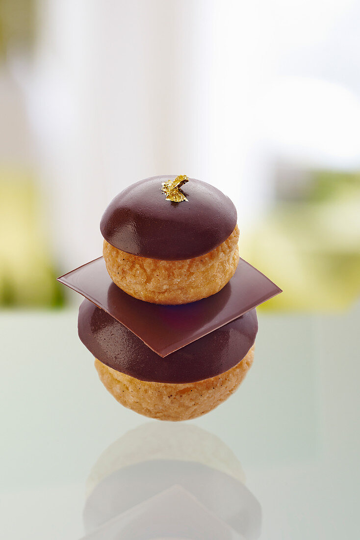 A chocolate religieuse with gold leaf