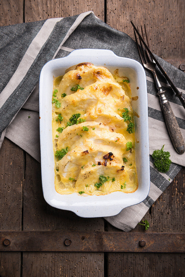 Celeriac gratin in a creamy cashew nut sauce topped with vegan cheese