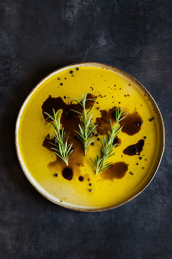 Olive oil and balsamic vinegar dip or dressing with pink salt and rosemary