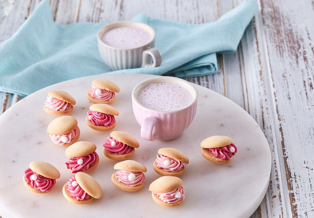 Sweet shell biscuits with pink cream filling