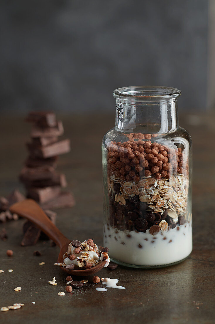 Ingredients for chocolate muesli layered in a glass jar