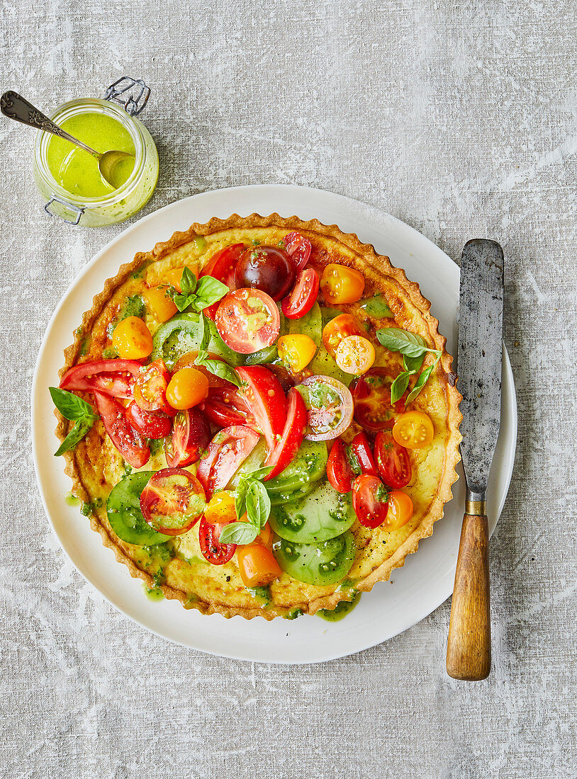 Tart with cheese filling and different kind of tomatoes