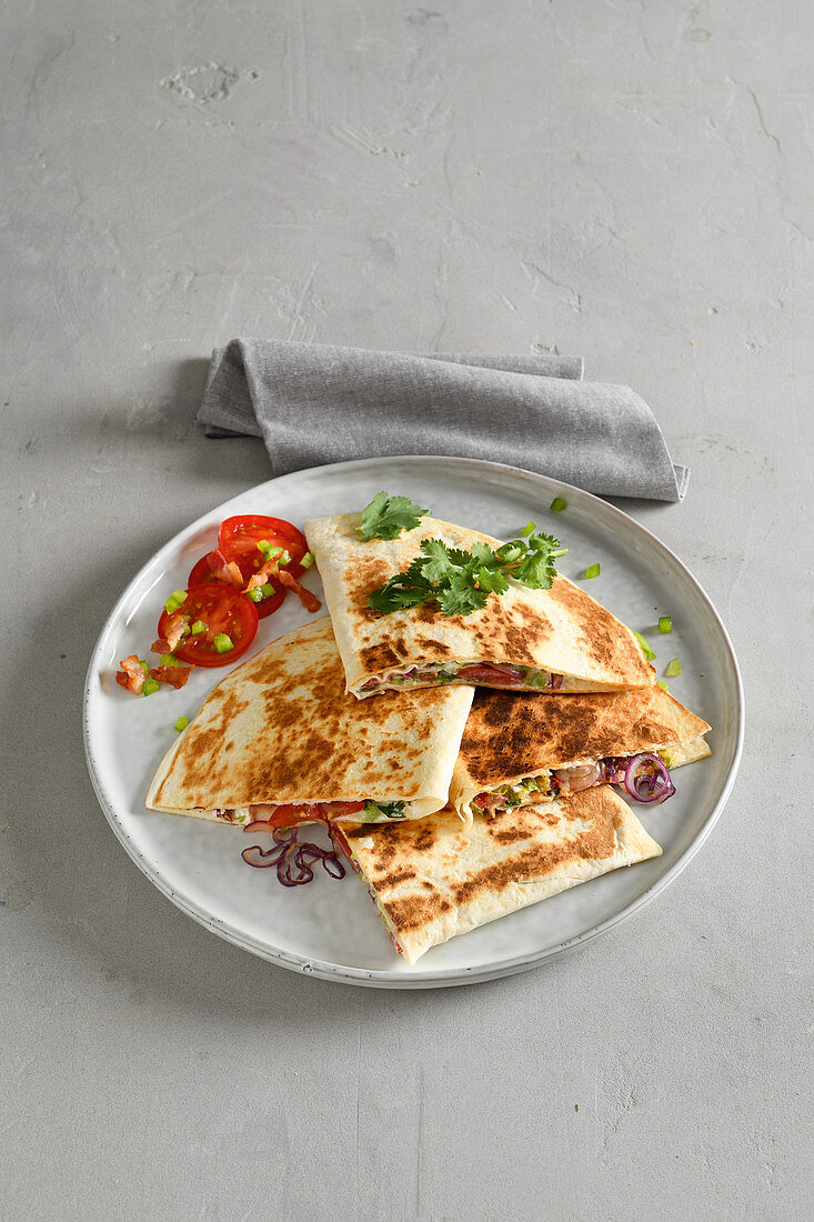 Stuffed quesadilla sandwiches with pepper, bacon and sour cream