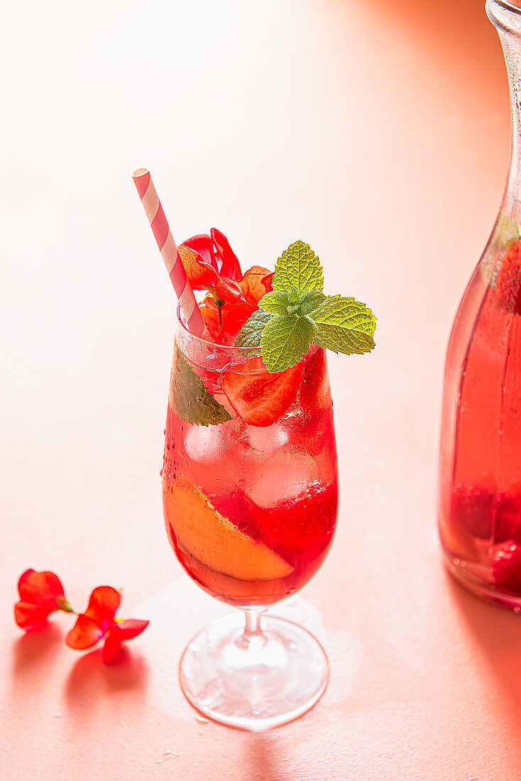 Summer iced punch with fresh raspberries, strawberries and peaches